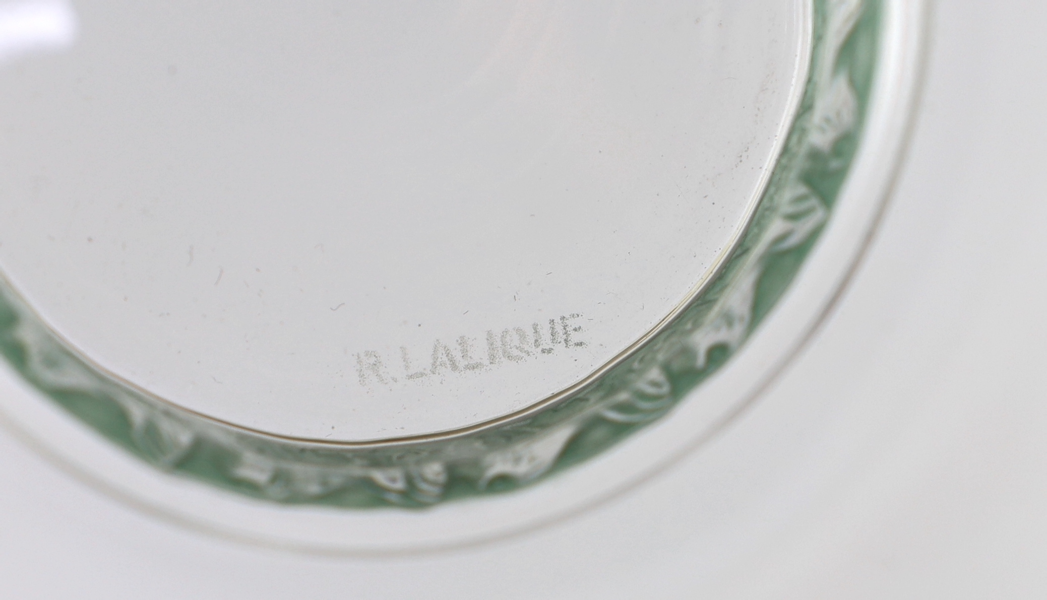 A set of eight R. Lalique Dampierre pattern bowls, model no. 3136, designed 1932, each moulded with a blue stained band of birds around the base, etched mark, 12.1cm diameter one bowl with tiny rim chip